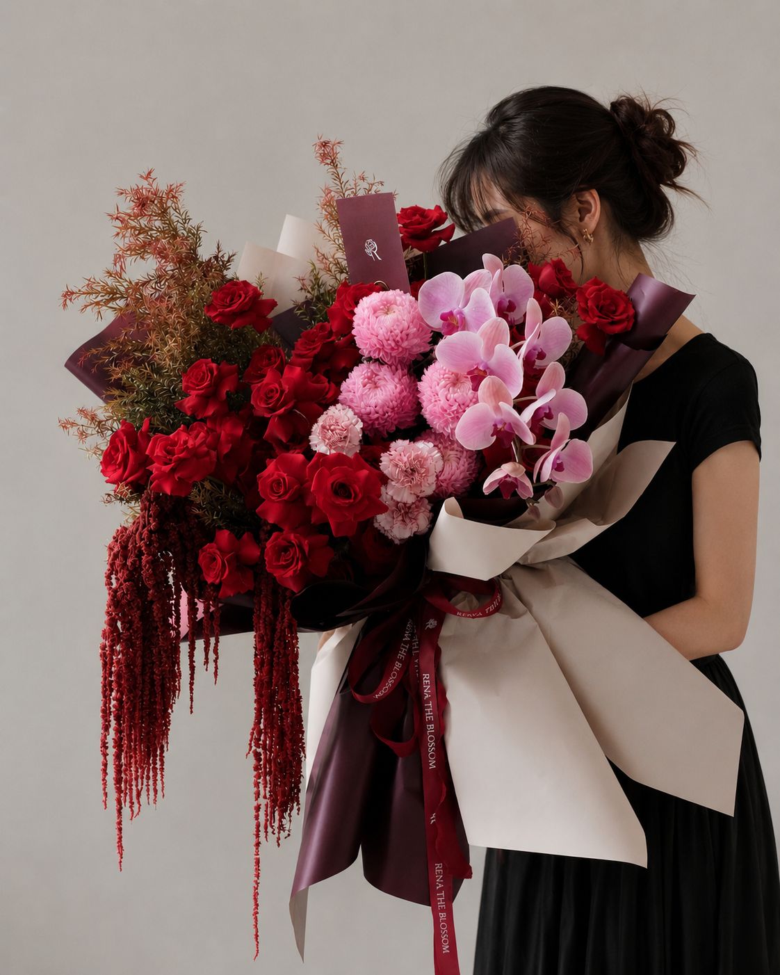 Woodland Rose - A romantic garden of deep red roses, cascading purple orchids, and soft pink peony mums, brought to life with delicate carnations and wild red accents. The flowing amaranthus and pine foliage add a natural, woodland-like texture, creating a bouquet that feels untamed, elegant, and quietly enchanting. - Rena The Blossom Jakarta
